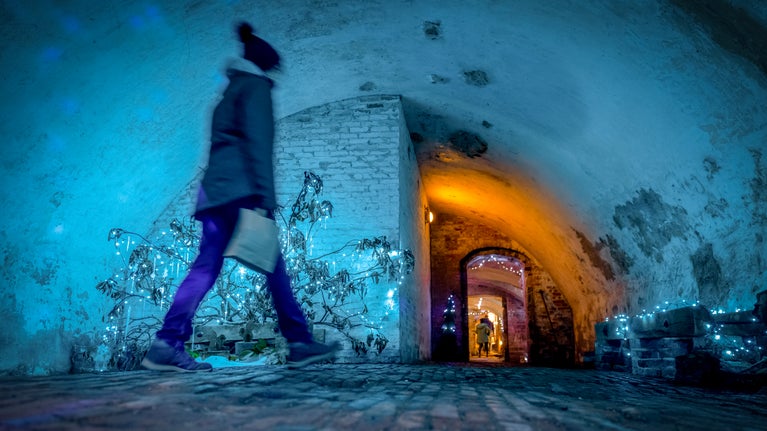Visitors exploring the festive tunnels at Calke Abbey, Derbyshire